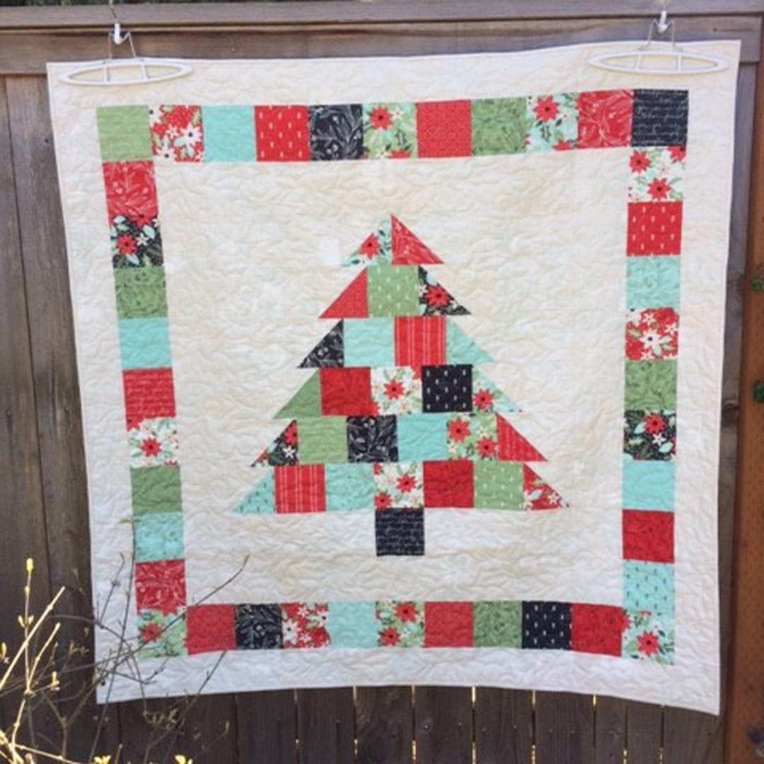 https://blog.fatquartershop.com/shortcut-quilt-charming-christmas-free-charm-pack-pattern/cynthia-brunz-little-tree-by-lella-boutique/