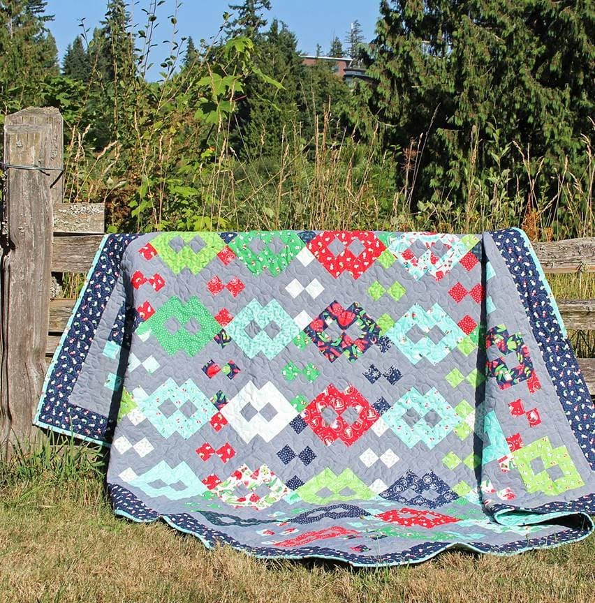 Large quilt draped over a fence