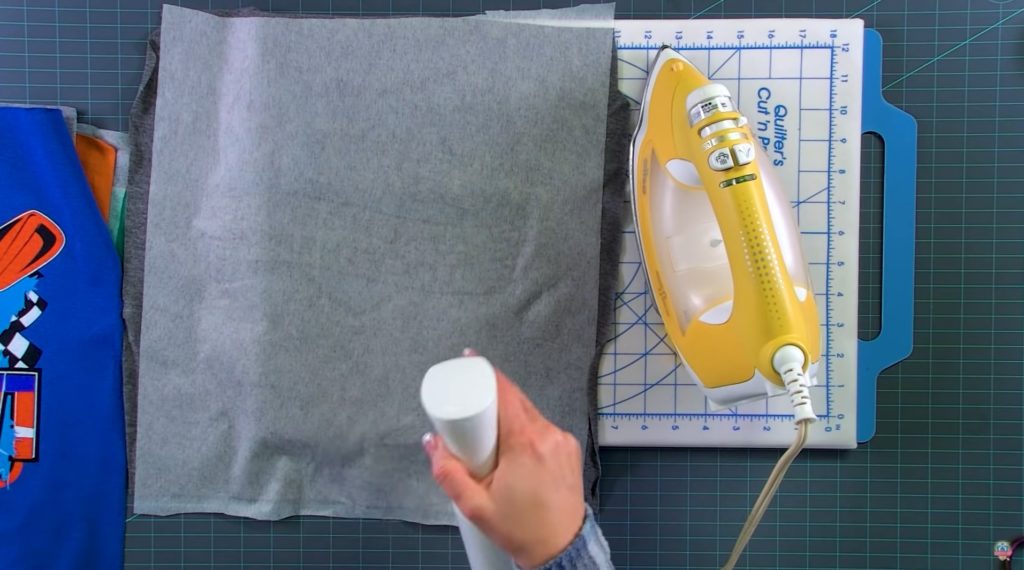 image showing the process of attaching interfacing to the back of a block for a t-shirt quilt