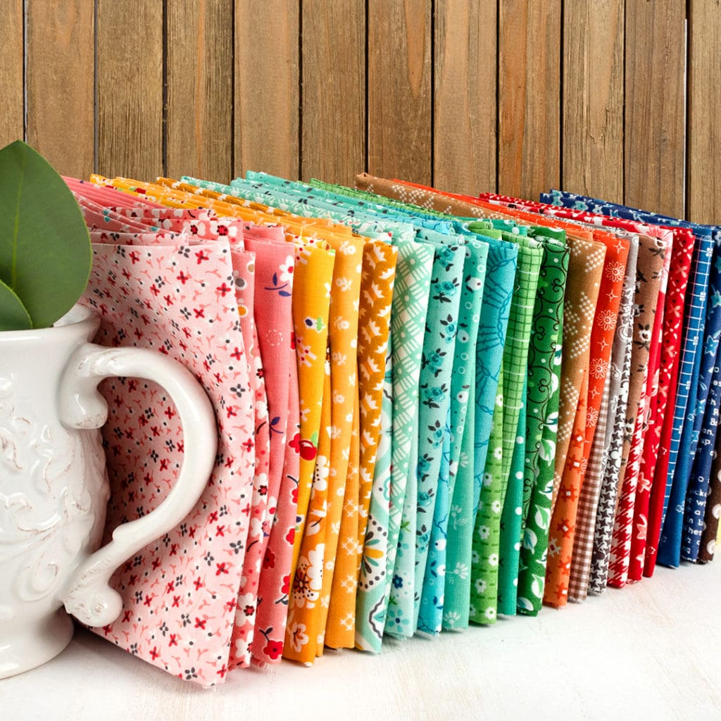 Image showing fabrics lined up together in a rainbow order to show off the Scrappy Starter Bundle