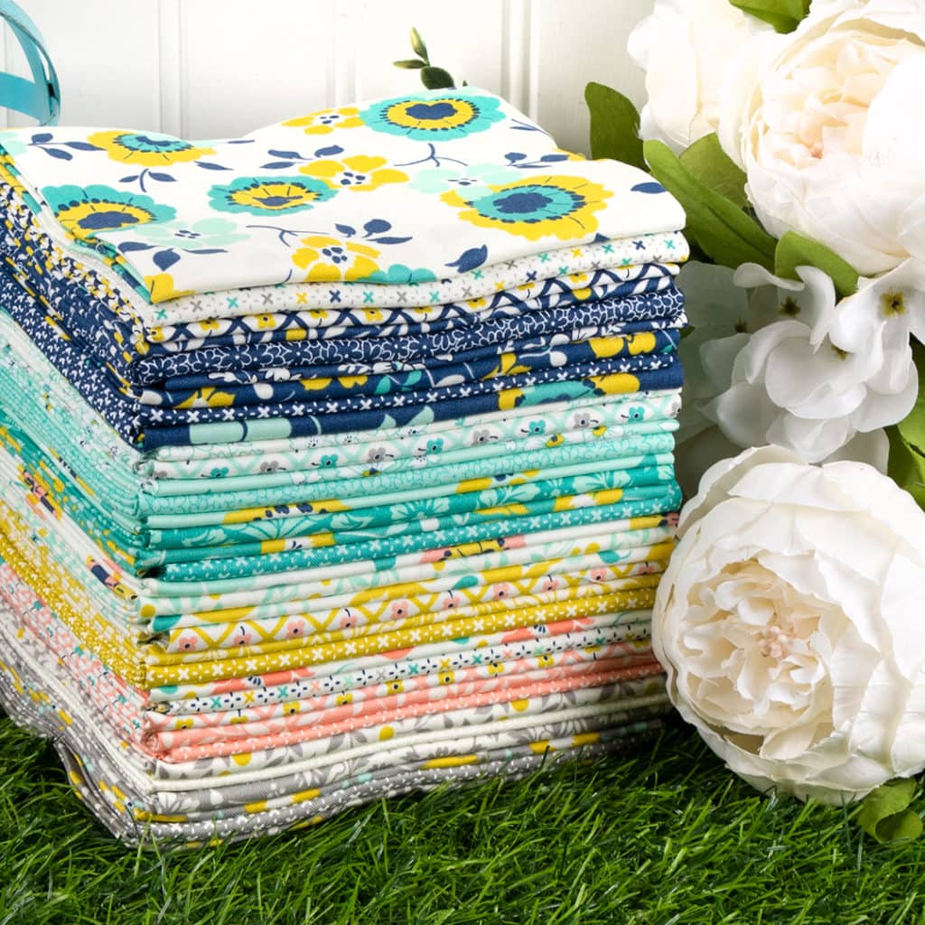 photo showing a stack of the morning light fabric collection that was used in making the mayflower quilt