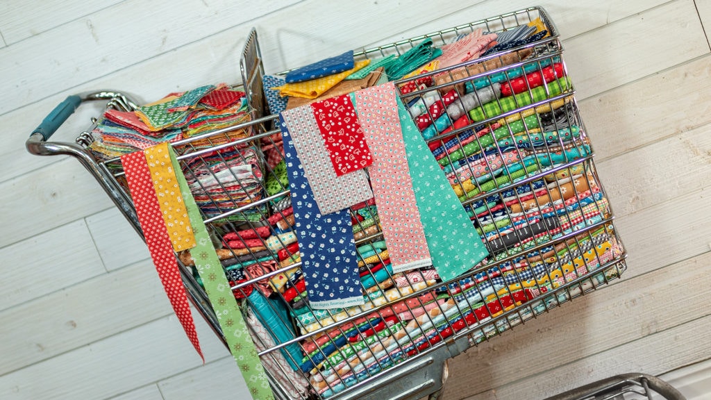 Photo showing a shopping cart full of fabric scraps  that have been collected by Lori Holt