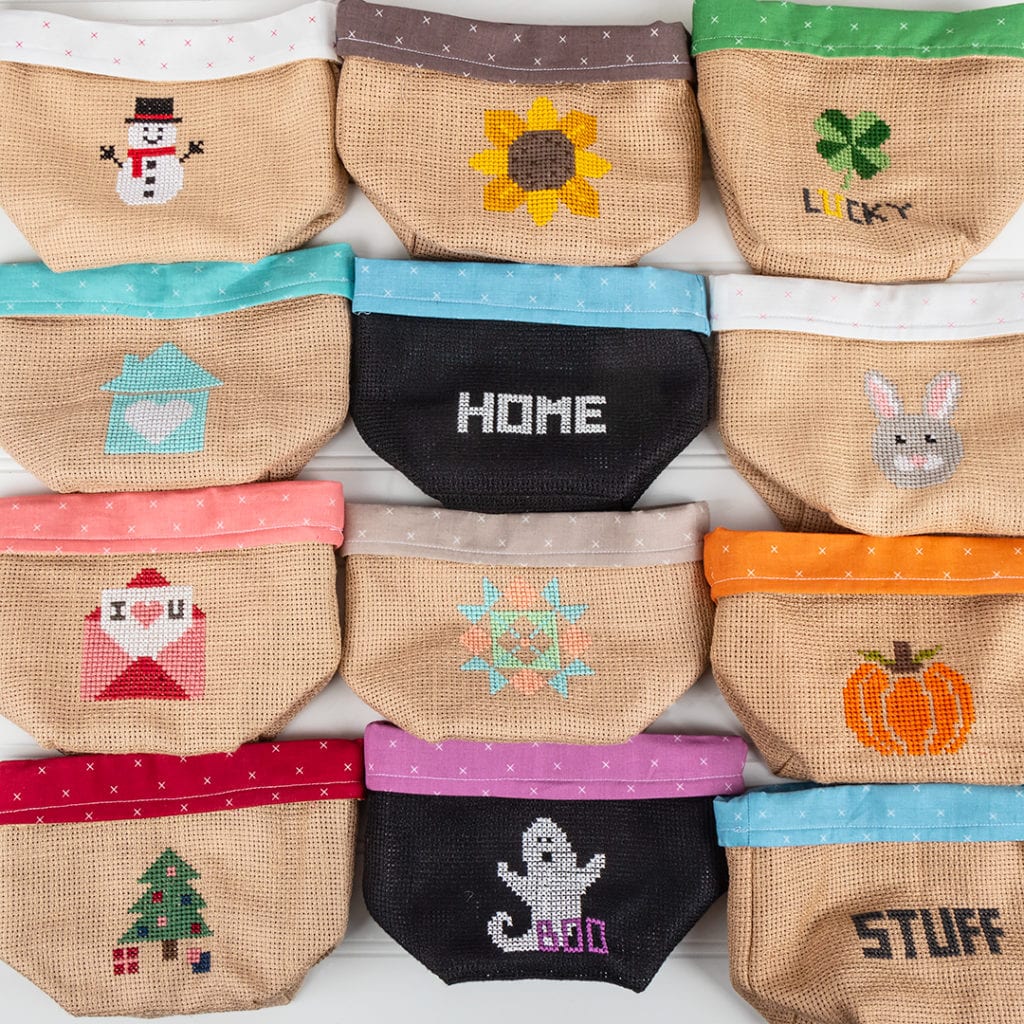 A variety of Bitty Bags all displaying different Petite Stitches Cross Stitch Patterns on them
