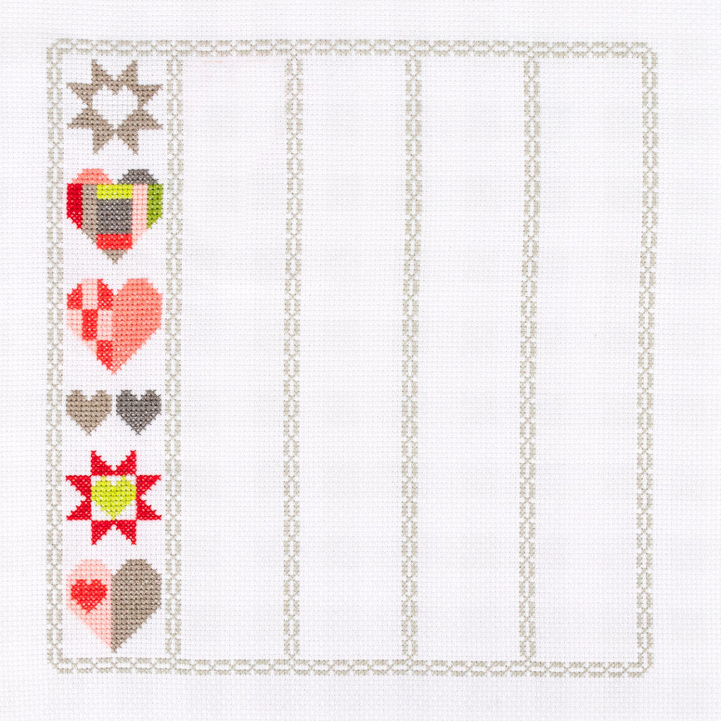 Image of cross stitch with one row of heartfelt charity fundraiser design done. The one row is the Release 2 design. 