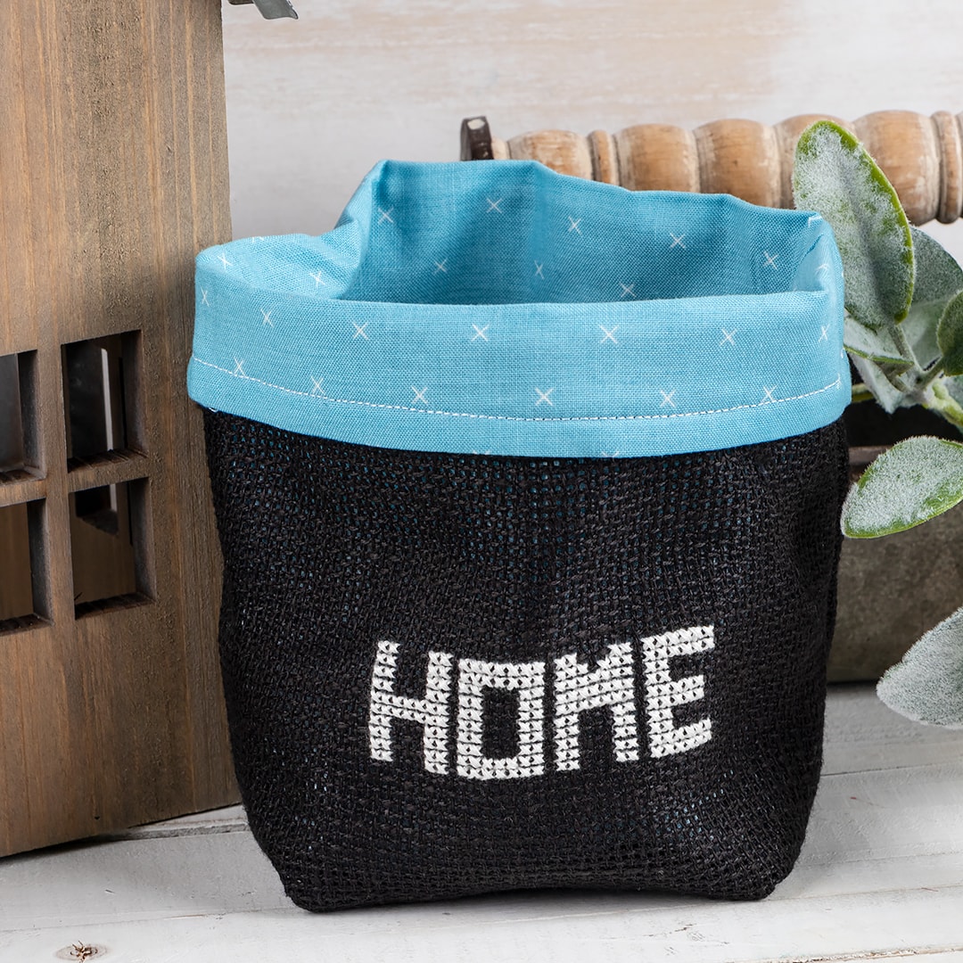 Petite Stitches: Home & Stuff which is a black bag showing the word "home" stitched on front