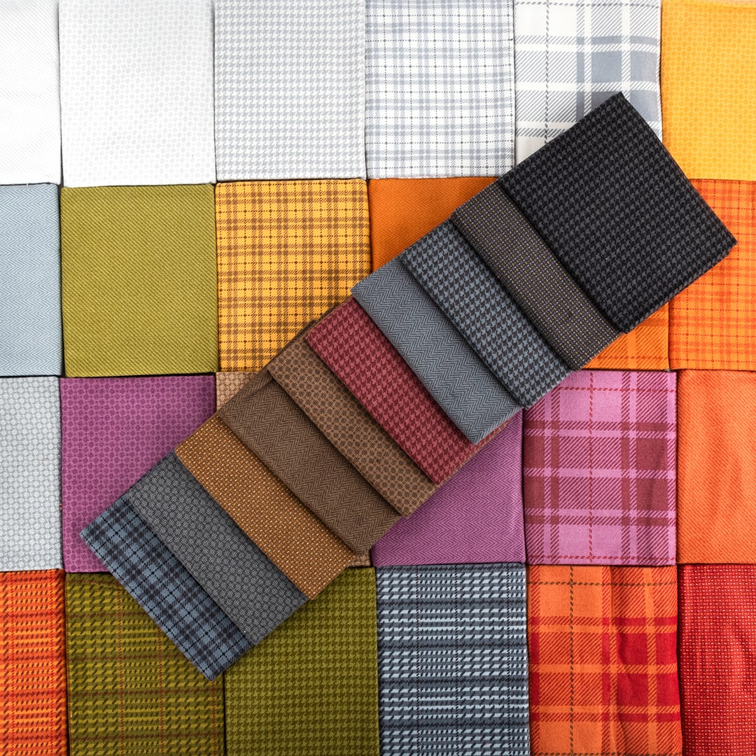 Autumn Gatherings Fabric Collection lain out across a table to show what flannel fabrics look like