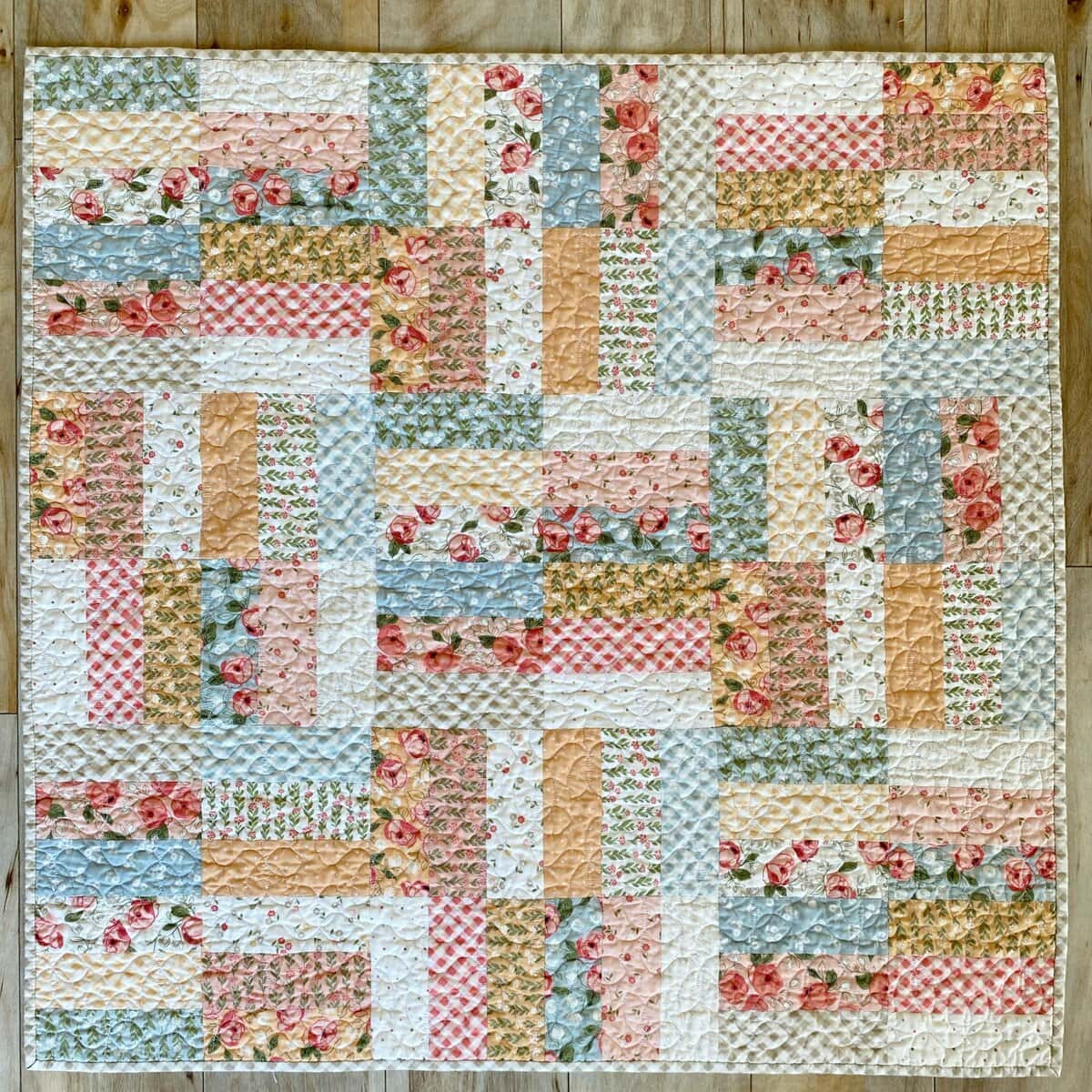 Emily Siddall, Brown Eyed Quilter, highlighted Country Rose by Lella Boutique for Moda Fabrics in this Jelly Roll Jam Quilt