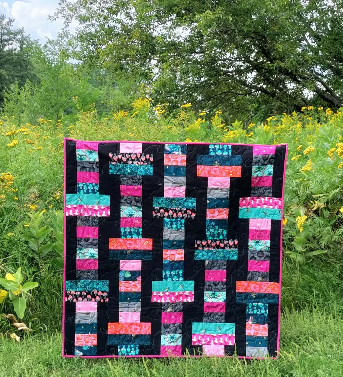 This Jelly Roll Slice quilt (right) was made by Laura Piland of Slice of Pi Quilts with Firefly by Sarah Watts for Ruby Star Society.