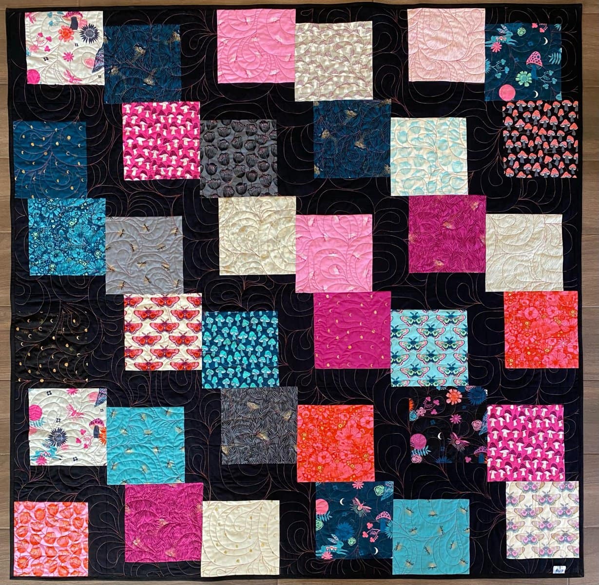 Afton used Firefly by Sarah Watts for Ruby Star Society and a Black Bella Solids Junior Jelly Roll.